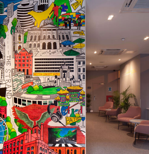 Colourful mural and cosy lobby seating at modern hotel, featuring vibrant cityscape art and comfortable armchairs.